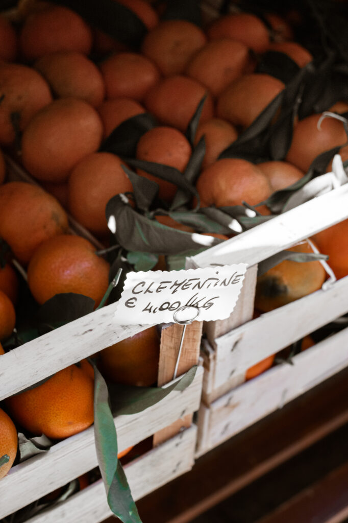 A tray of rustic oranges with green leaves